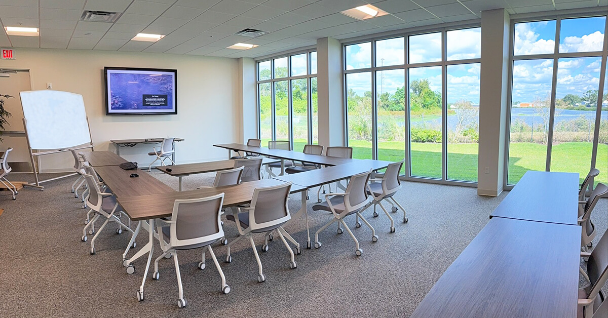 Main conference room at Codeware used for on-site software training and seminars overlooking pond.